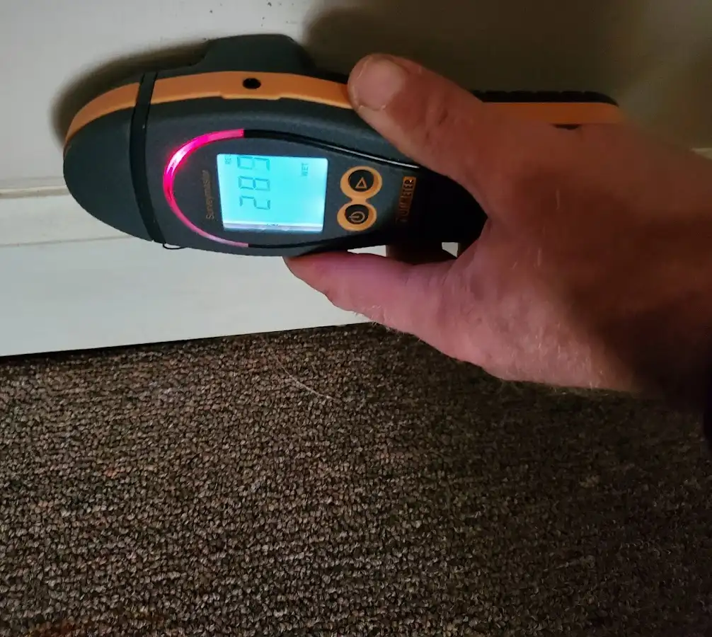 Moisture detection at baseboard during Storm Damage Restoration in Dos Palos